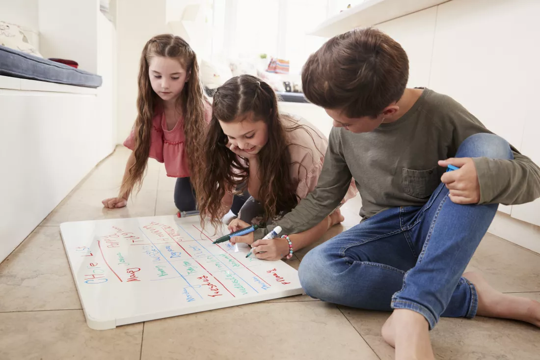 children-making-list-chores-whiteboard-home