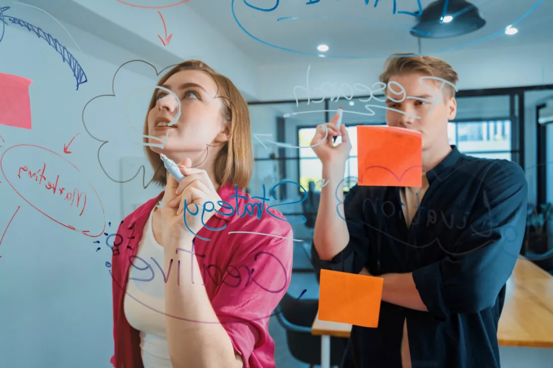 couple-young-creative-start-up-business-people-brainstorming-idea-solving-problems-by-using-sticky-note-mind-map-glass-board-meeting-room-discussing-working-together-immaculate